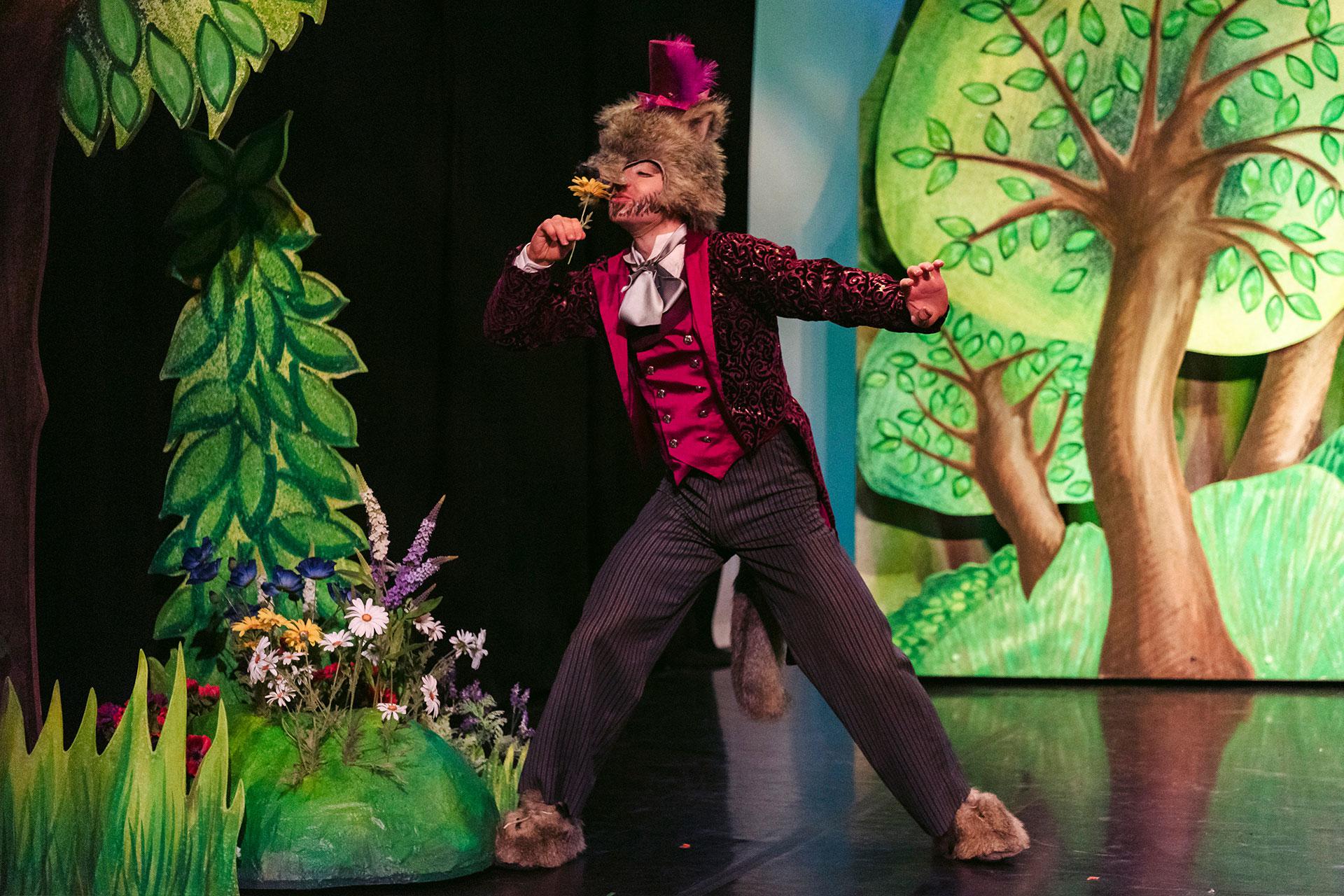 Wolf stops to smell some beautiful flowers