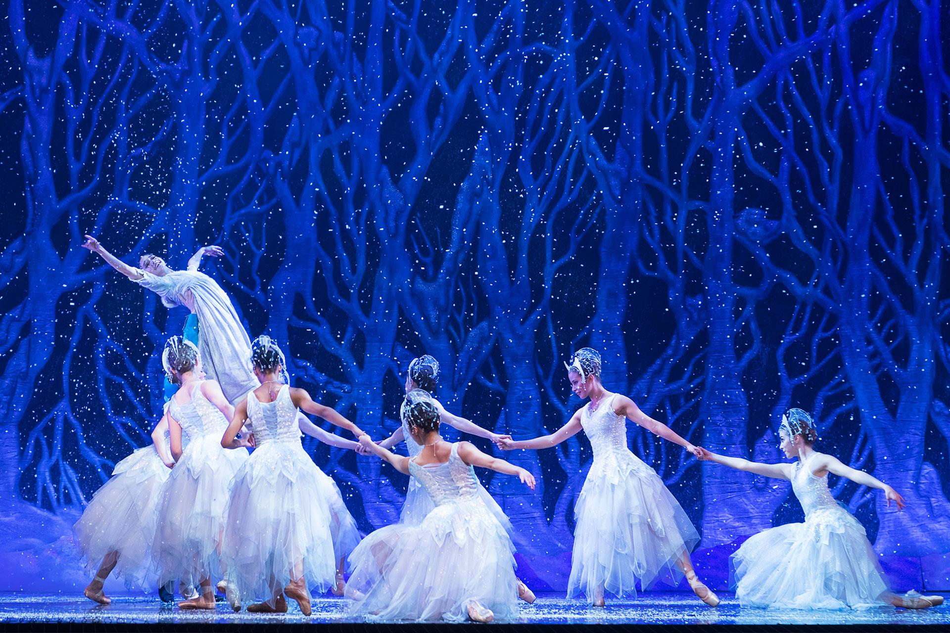 Clara is lifted high by her Prince surrounded by flurries of dancing sSnowflakes