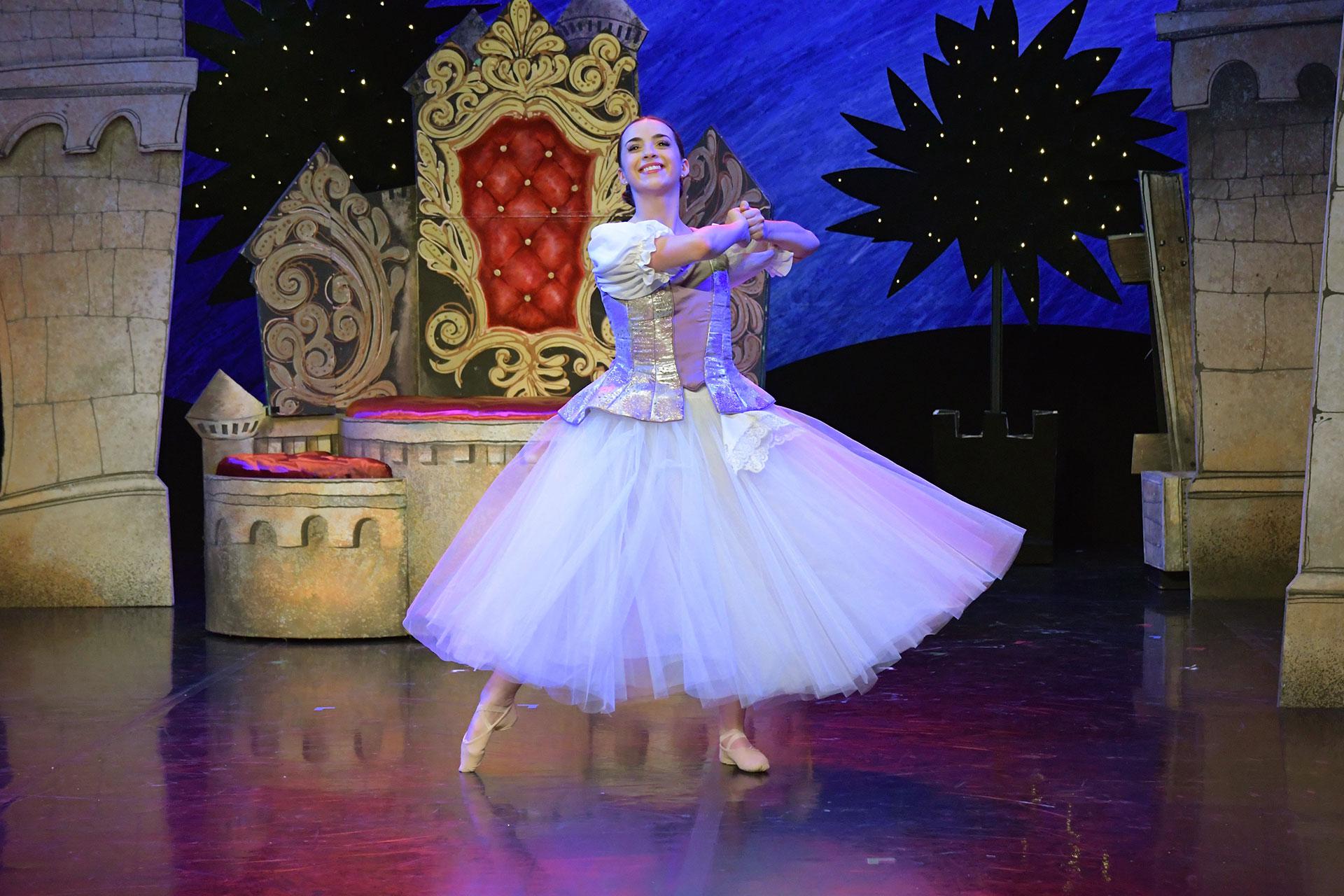 The Court Lady dances in her finery on front of the throne