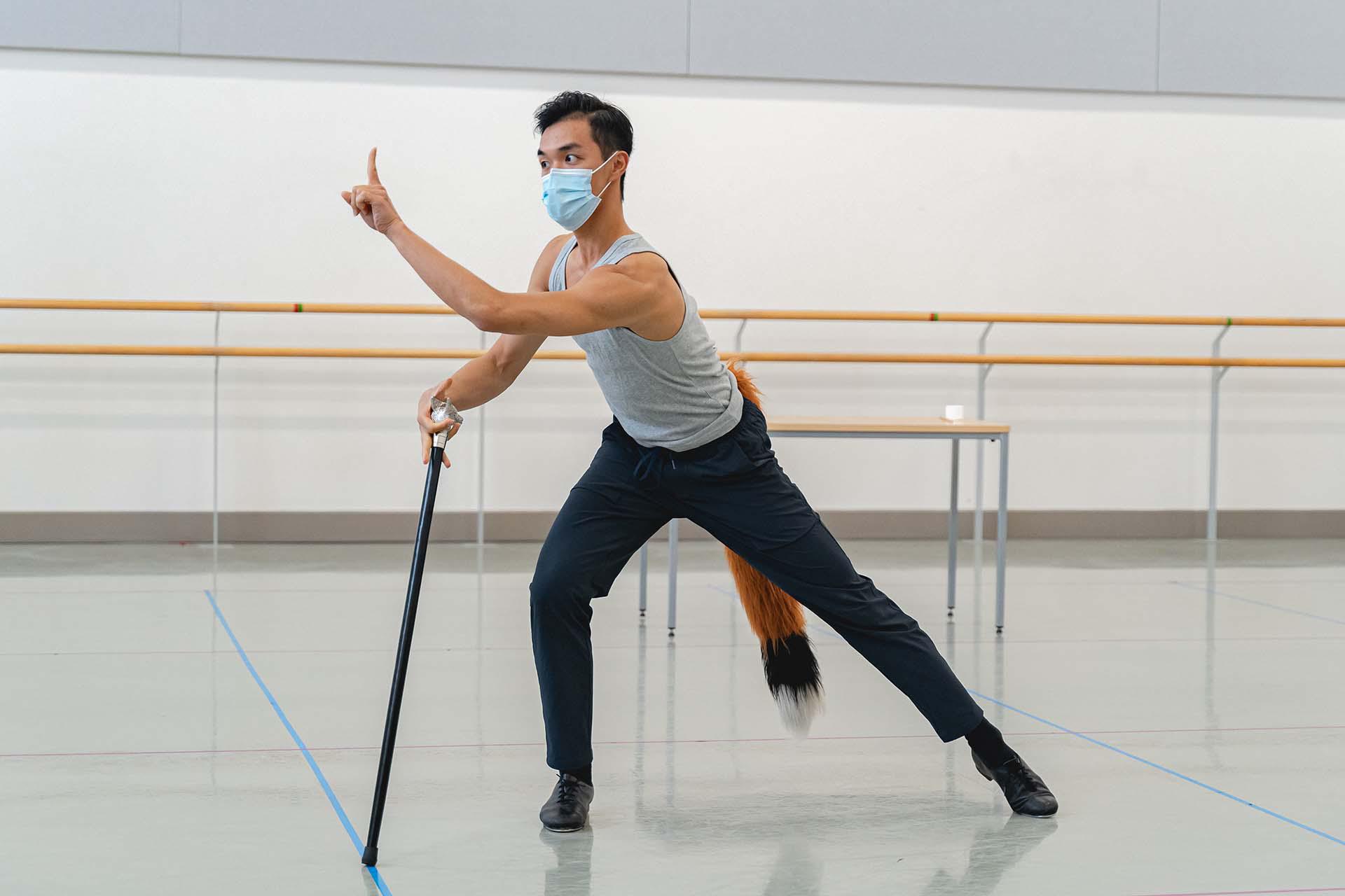 The fox leans forwards and wags his finger