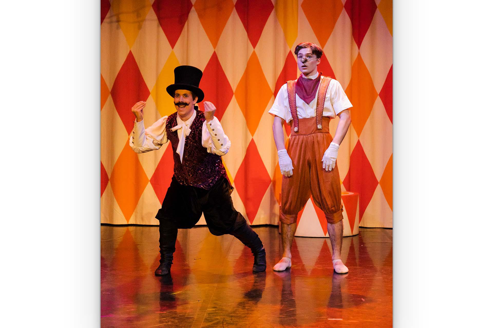 The Showman shows Pinocchio gleefully on his circus stage.