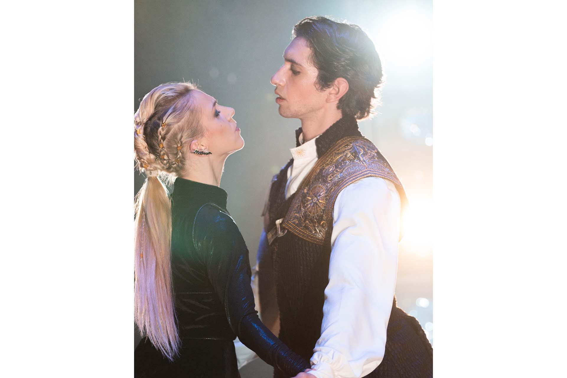 A woman looks up seductively at a man