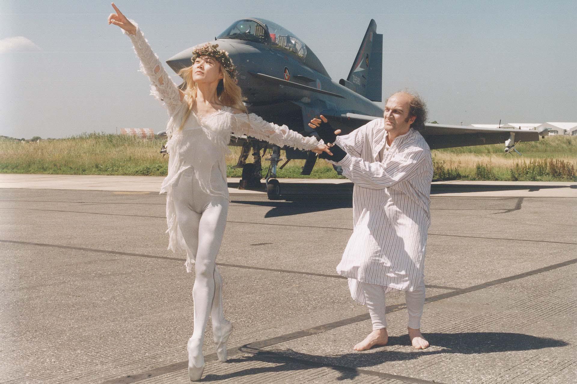 Press photo for A Christmas Carol with characters in front of a British Aerospace fighter jet