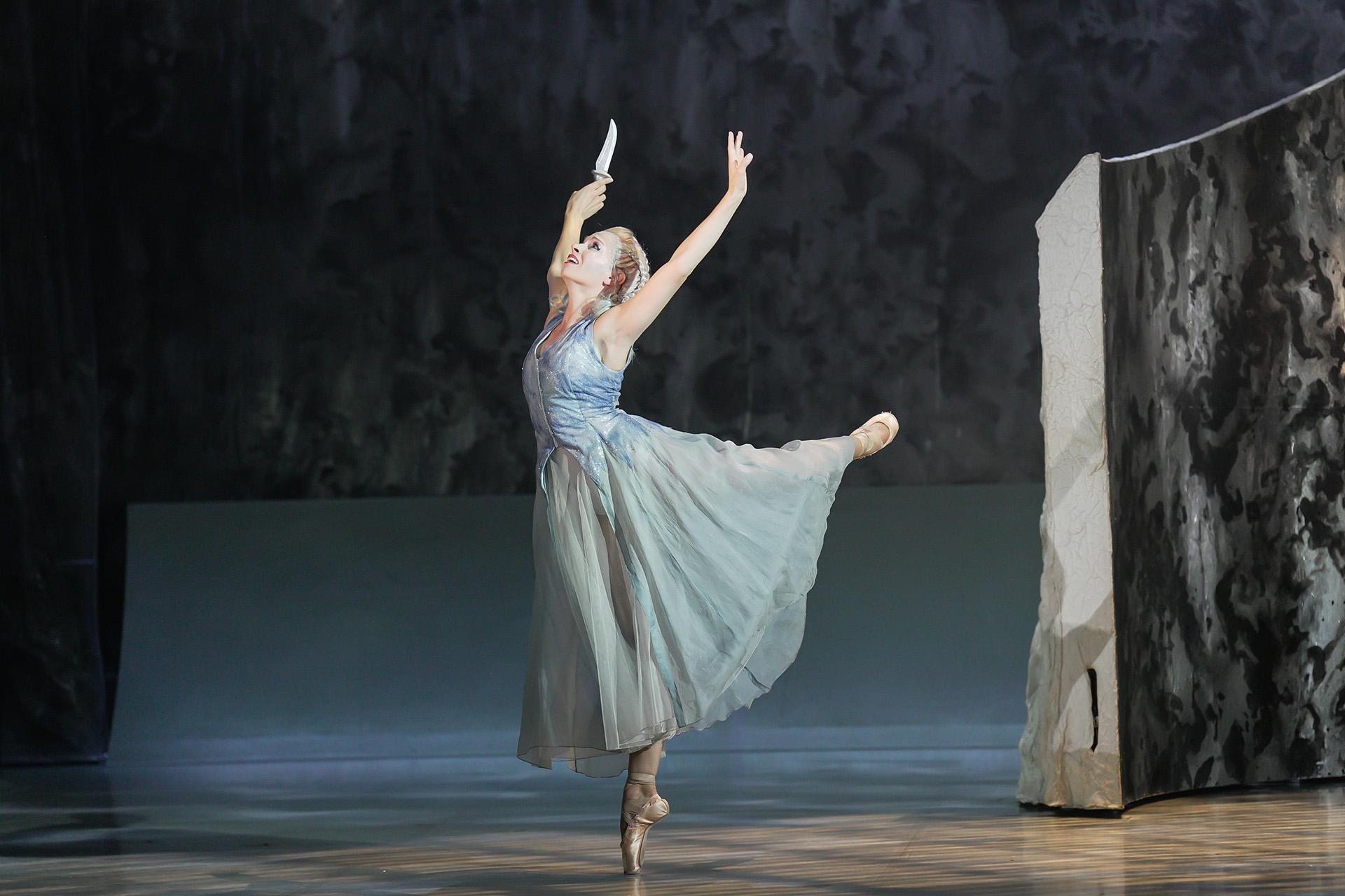 Marilla dancing alone in arabesque and a pained expression on her face