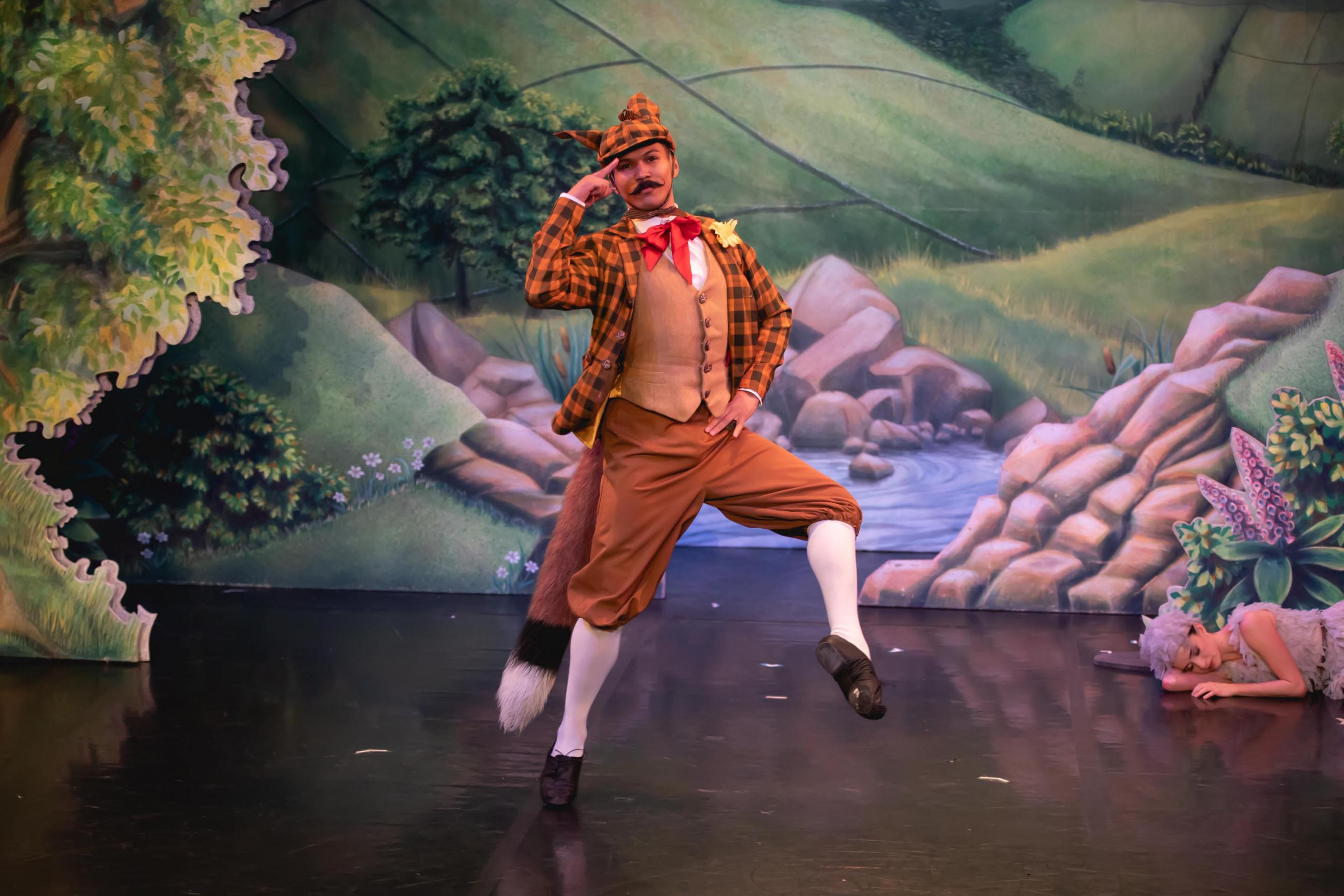 Dancer in a fox costume stood on one leg