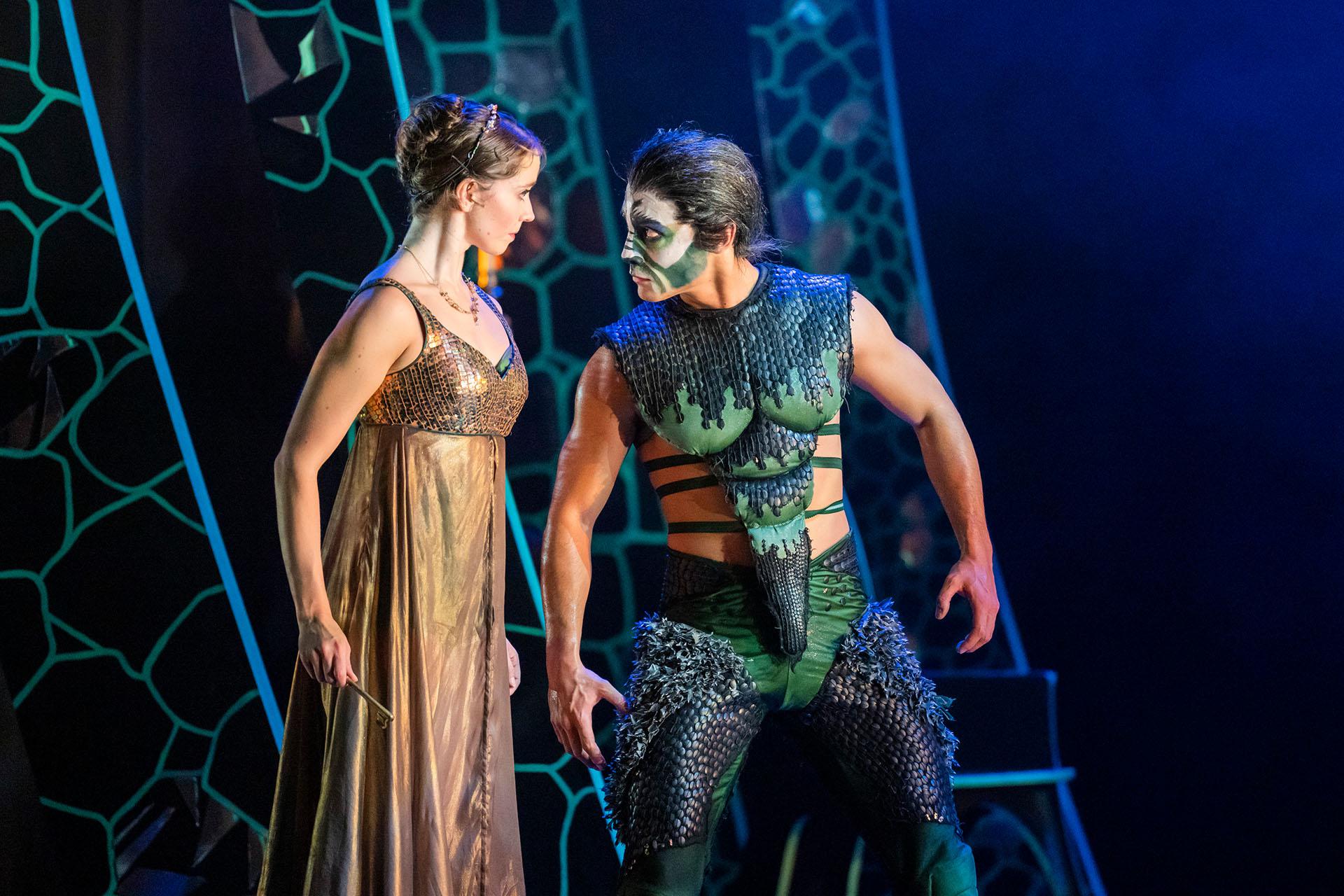 Beauty and Beast stand close and stare intensively and each other, both uncertain of the other