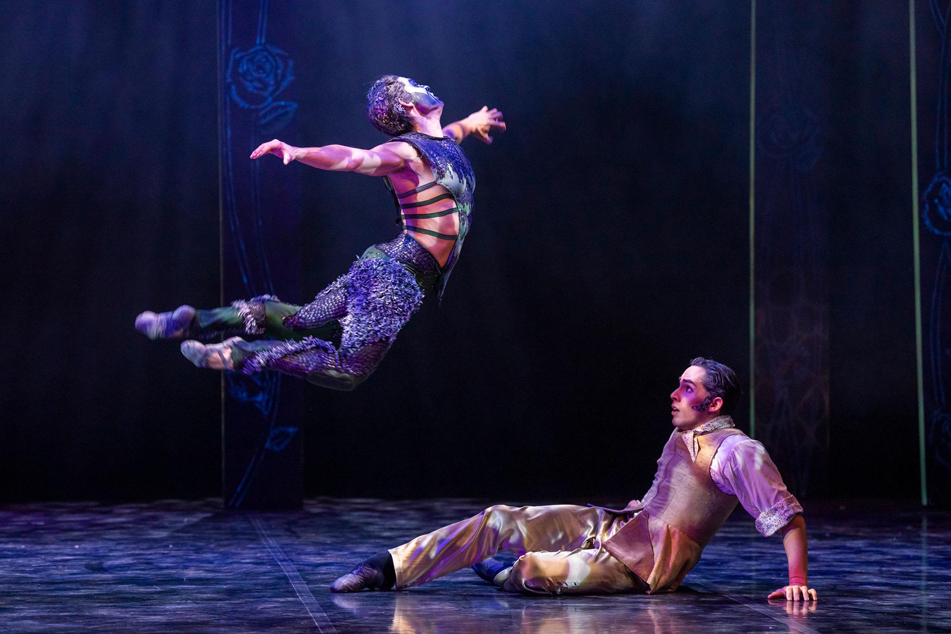 The Beast leaps menacingly while Beauty's father looks on, scrambling away