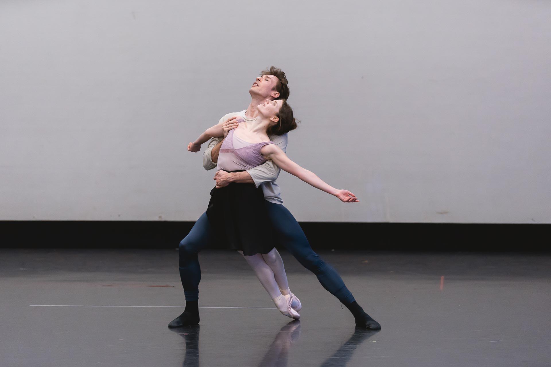 Two dancers leaning forward in an embrace