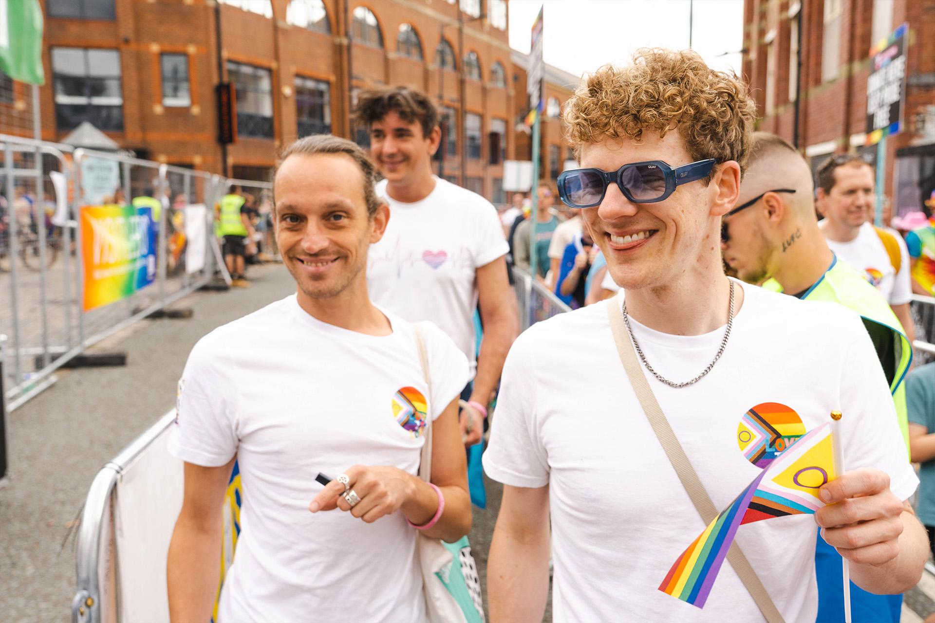 Dancers marching in Pride smiling widely