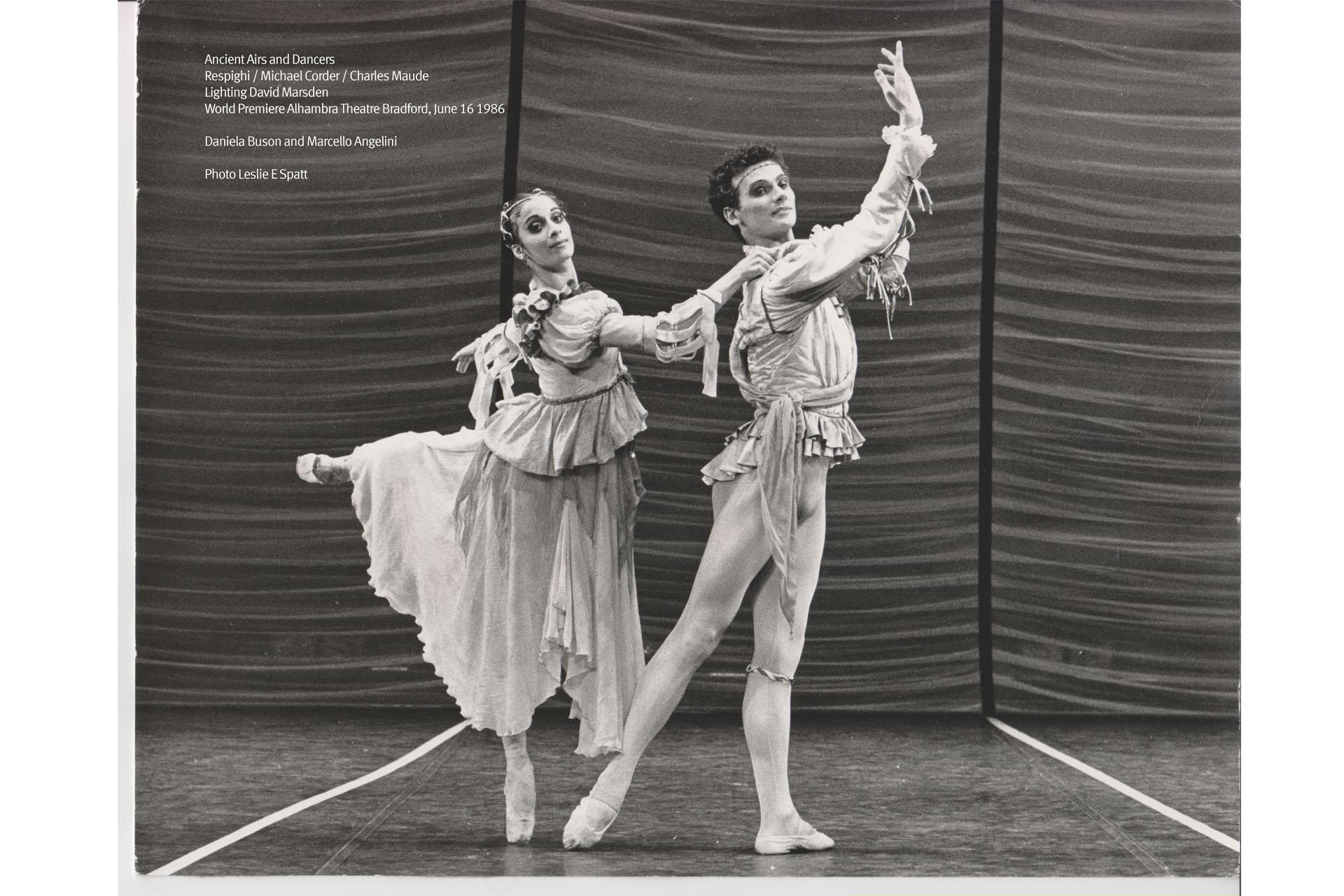 Black and white photo of two dancers stood in a pose with arms and legs raised