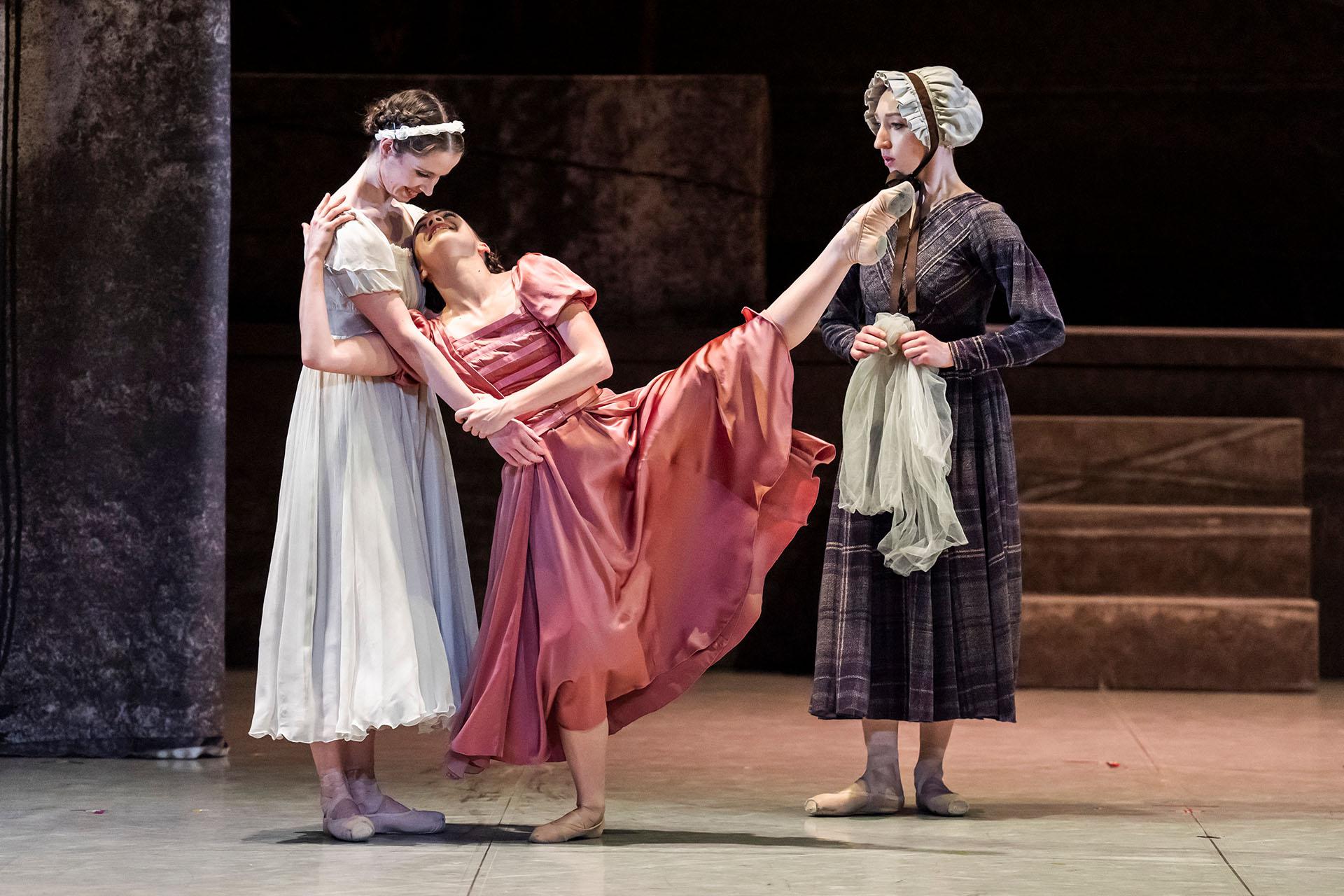 Jane in white hugs with Adele in pink, but very happy as a stern Mrs Fairfax looks on