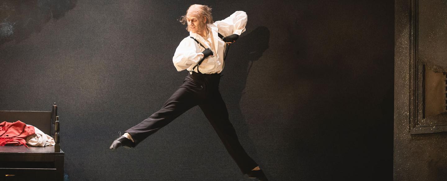 Scrooge in the morning after his spectral visitors leaps joyously while getting dresses