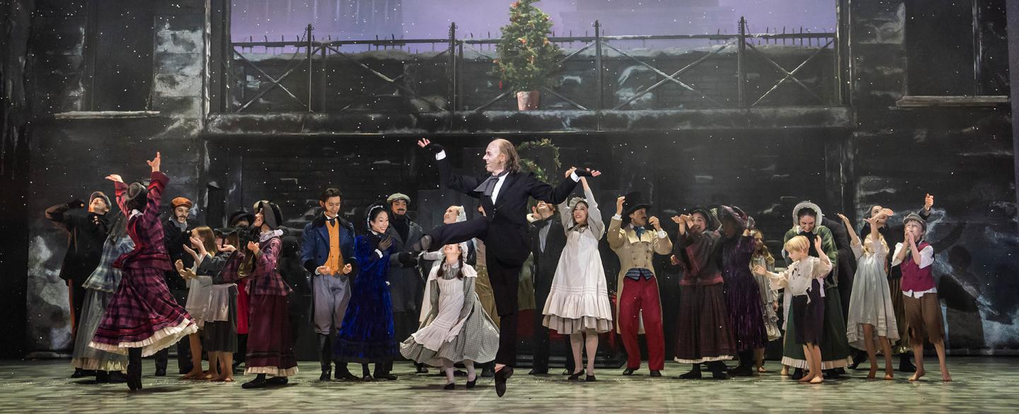 A dancer on stage jumping up in joy