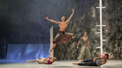 Wearing a leather kilt, Prince Adair leaps high on his ship