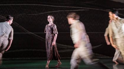 Jane Eyre slowly moves across stage contemplatively, those moving around her are in a blur