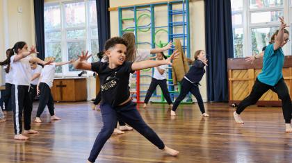 Boy in school hall expressing himself through dance